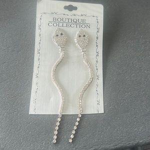 Brand new! Never worn. Snake dangle earrings. Clear rhinestones, black eyes